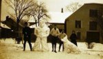 Roger Hayward, two unknown individuals, and Betty Hayward, posing with their snow creations, ca. 1923.