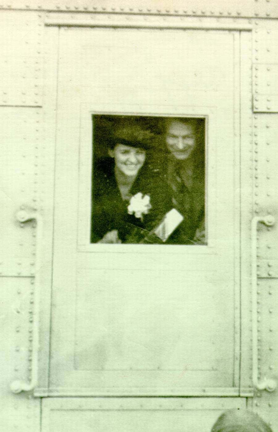Ava Helen and Linus Pauling peeking through the window of the Union Pacific Streamliner City Of Los Angeles.
