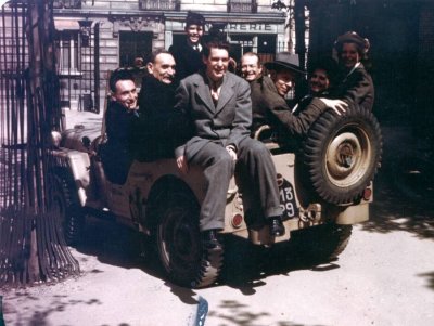 Members of the Pauling family crowded into a Jeep with Professor Bauer, Robert Millikan and others, Paris France. Picture. 1948