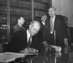 Linus Pauling signing the guest registry at the Weizmann Institute of Science library.