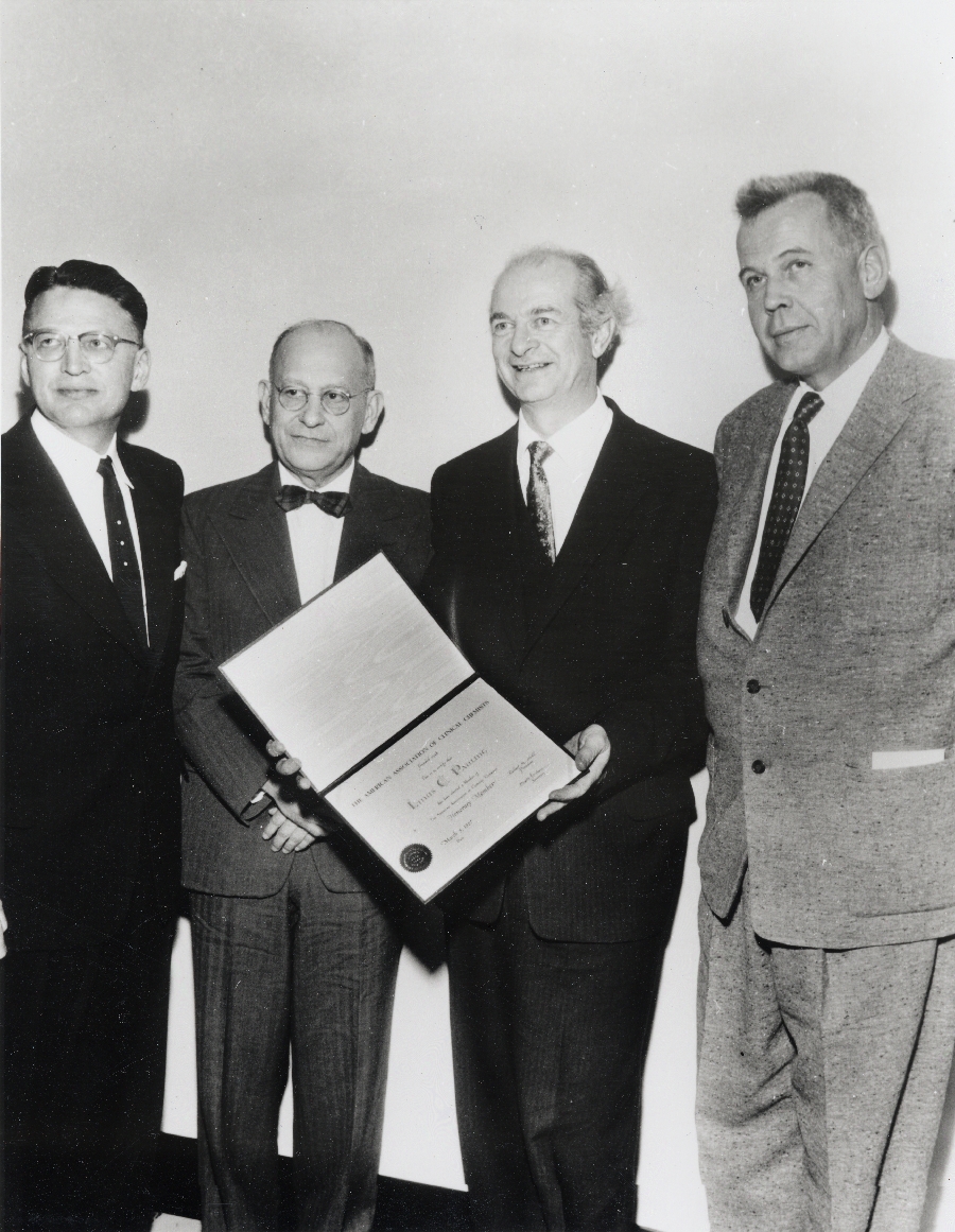 Linus Pauling receiving an honorary membership to the American Association of Clinical Chemists. From left to right: Kenneth Johnson, Robert H. Hill, Pauling and William Bergren.