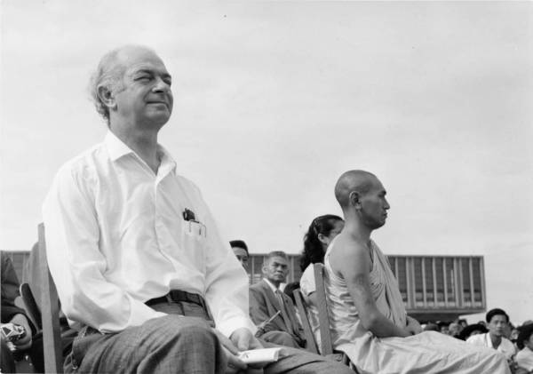 Linus Pauling sitting next to a Buddhist monk, Hiroshima, Japan. Picture.