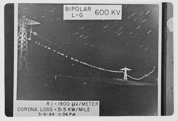 Night photograph of corona phenomenon on power lines. Within envelope labeled "BPA DC Test Sites."