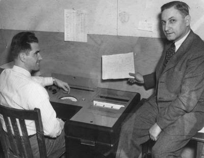 <p>Dr. Robert R. Reichart and Lawrence W. Carrillo, Jr. using a machine to check tests for the counseling and testing service, 1949. Robert R. Reichart received a B.S. in Commerce from Oregon State University in 1917 <span class='highlight2 bold'>and</span></p><p>				retired in 1974 as a Professor Emeritus of both Education <span class='highlight2 bold'>and</span> Forestry. Reichart taught courses in educational psychology, his focus centered on a student's ability to learn on their own using multimedia resources.</p><p>				Eventually Reichart created a center for self-learning on campus.</p>