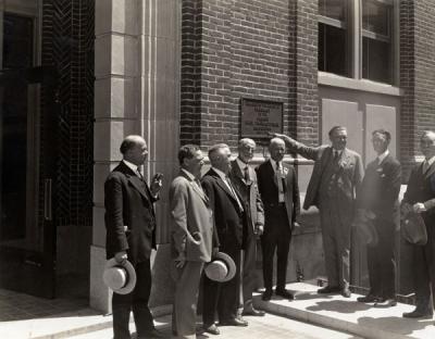 <p>Pharmacy Building dedication, July 1925. Pictured from left to right: E. L. Necomb, F. R. Peterson, Frank S. Ward, William F. Woodward, Pharmacy Dean Adolph Ziefle, A. E. Cosby, H. <span class='highlight0 bold'>S</span>. Noel, J. K. Weatherford. Components of</p><p>				the OSC Clippings scrapbooks are believed to have been assembled by Adolph Ziefle.</p>