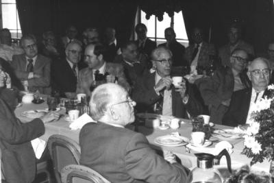 <p>Delmer Goode and Herman Scullen (far right) at the Triad Club head table, ca 1970s. Delmer Goode became Assistant College Editor in 1919, eventually serving as the Director <span class='highlight2 bold'>of</span> University Publications from 1943-1956. In</p><p>				1919, Goode founded Troop 1 of the Boy Scouts <span class='highlight2 bold'>of</span> <span class='highlight3 bold'>America</span>. Herman Scullen was a honey bee entomologist from 1920-1953. During Scullen's years in the Entomology department, the wasp collection increased dramatically. The</p><p>				Herman A. Scullen Memorial Fellowship was established for graduate studies in apiculture.</p>