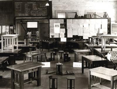<p>Industrial Arts workshop, ca. 1910s. Image shows examples of furniture designed and constructed by Oregon Agricultural College students. The cabinet work course included the mixing and application <span class='highlight1 bold'>of</span> stains, fillers, and</p><p>				various finishes; the design and construction of drawers and panel work; and primary upholstering. Many <span class='highlight1 bold'>of</span> O. A. C.'s industrial arts students became teachers at the secondary and vocational level.</p>