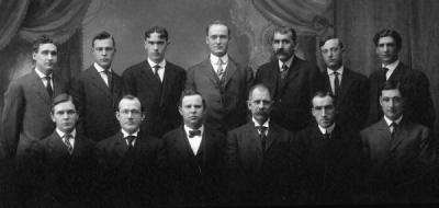 <p>Group photo of the School of Engineering and Mechanic Arts Faculty, 1909. Front row (L to R): Willibald Weniger; Thomas Mooney Gardner; Gordon V. Skelton; Grant Albert Covell; Henry <span class='highlight1 bold'>M</span>. Parks; and Mark Clyde Phillips. Back</p><p>				row (L to R): C. L. Knopf; Earl Vincent Hawley; Samuel Herman Graf; E. P. Jackson; William McCaully Porter; Herbert Edward Cooke; and Wilford W. Gardner.</p>