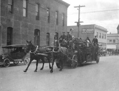 Corvallis Fire Department, 1914. Shown on Madison Street near the Masonic Building and City Hall. Image is of the only horse team the fire department ever had.