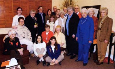 Geraldine Olson, fourth from left (standing), at a gathering organized in her honor, CH2M-Hill Alumni Center, 2002.