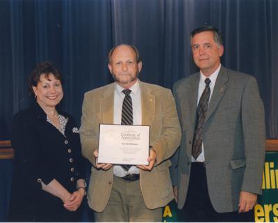 Gerald W. Williams (center) receiving a Certificate of Appreciation from Ann Veneman, U. S. Secretary of Agriculture, and Forest Service Chief Dale Bosworth.