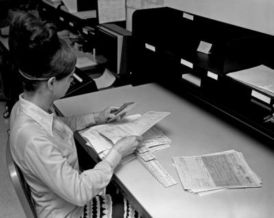 A University Archives student arranging records for filing, ca. 1970s.