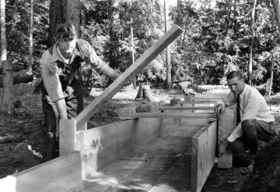 Arthur King, soil specialist, demonstrating how to build a flume, ca. 1930.