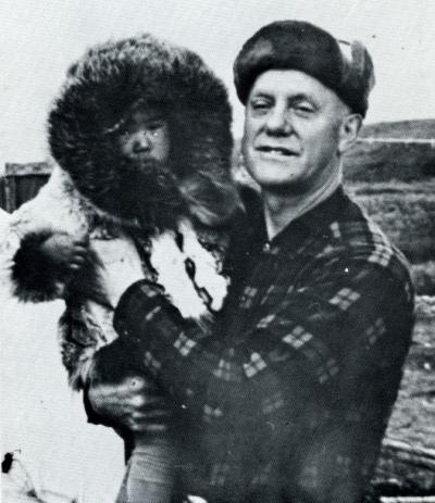 Paul H. Jensen and an Alaskan Eskimo child. Image extracted from Jensen's publication "Hunters of the Arctic Rim," circa 1960s.