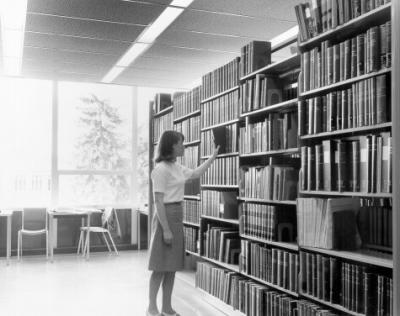 A student browsing in the Kerr Library, 1966.