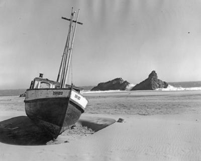 "Neptune's toll." A wrecked fishing boat on the sand at Brookings, Oregon, ca. 1930s.