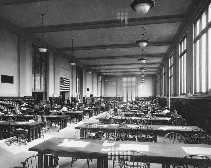 Ida Kidder (foreground) seated in the Oregon State College library, ca. 1910s