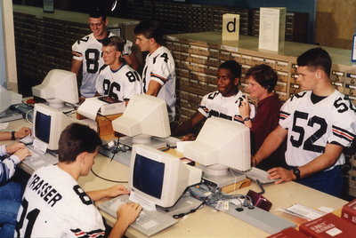 Football players using library computers