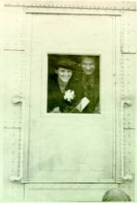 Ava Helen and Linus Pauling peeking through a train window, Los Angeles, 1938.