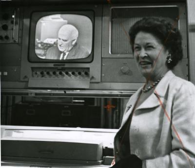 An unidentified women in front of a television studio monitor showing UPI Chief Frank Bartholomew, 1960.