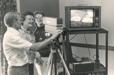 Glenn Klein providing instruction on how to use videotape equipment, 1980.