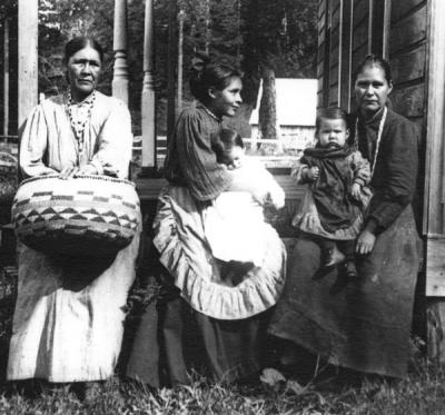 Siletz Indians, undated. From left to right: Mrs Bensell; Mrs. Mennard and baby; Mrs Ada Collins and son, Maxwell Collins.