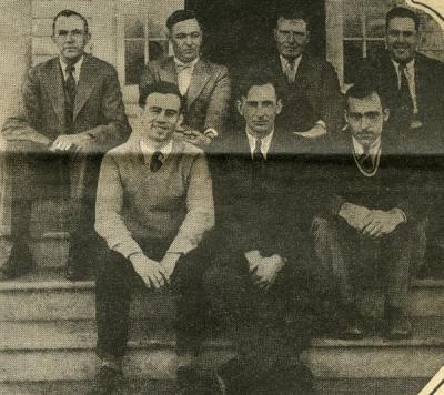 Image from a  article titled "Wage Wireworm War." Caption reads: "M. C. Lane and his crew." Merton Lane is seated front row, center.