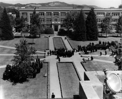 Graduates gathering in the Memorial Union quadrangle and forming an orderly procession to the Men's Gymnasium, 1949.