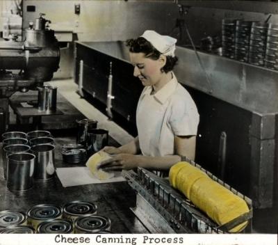 Hand colored photograph of the cheese canning process, ca 1930s.