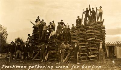 Postcard annotated "Freshmen gathering wood for bonfire." Ca. 1910s.
