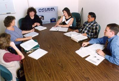 OSU Management Association Board Meeting, 1999. OSUMA members (pictured from left to right) Tammy Kreig, Beth Rietveld, Debbie Jimmerson, Laurel Busse, Gideon Alegado, and Chad Klaus consider new ways to connect OSU professional staff to resources in the university community and elsewhere.