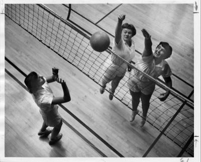 Unidentified women playing volleyball, ca. 1950s.