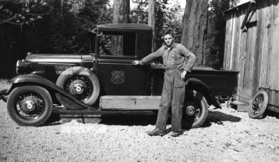 A Forest Service staffer posing with his truck at the Oakridge Civilian Conservation Camp F25, Co. 943, Willamette National Forest, 1934.