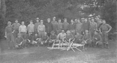 "The Foresters Ready for the Tall Timber," ca. 1912. Forestry professor George W. Peavy (kneeling, left) poses with members of the Forest Club. The club held two meetings a month, one of which was devoted to forestry issues and business matters of the club. The other was social, and occasionally took "the form of a night's vigil in the forest, where, seated around the camp fire, stories are told and songs are sung, while the aromatic odor of camp coffee is wafted on the air, and 'overland trout' frizzles in the frying pan."