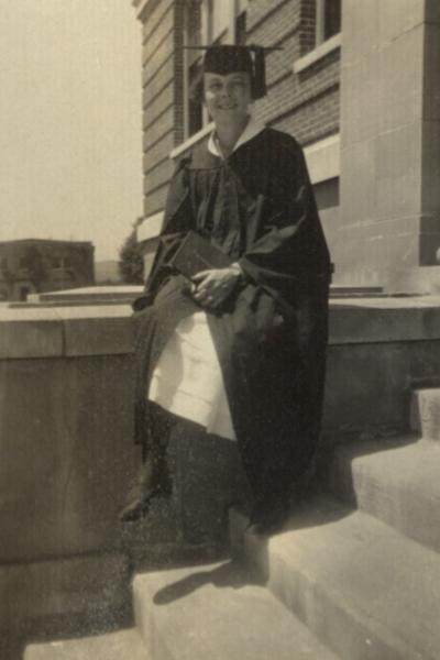 A woman, tentatively identified as Helen H. Marburger, in graduation cap and gown, 1925