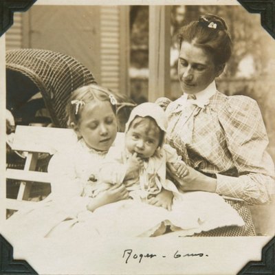 Black and white photograph of Hilda, Roger and mother Ina Hayward seated together on a bench.