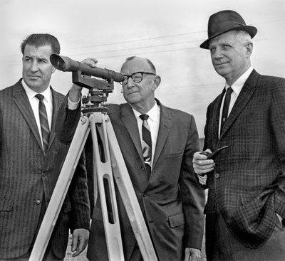 Black and white photograph of James Herbert Jensen with Cy Everts looking through a telescope.